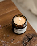 Purbeck Candles candle on a wooden surface with dried flowers