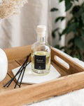 Bottle of Eurus on a wooden tray with decorative items