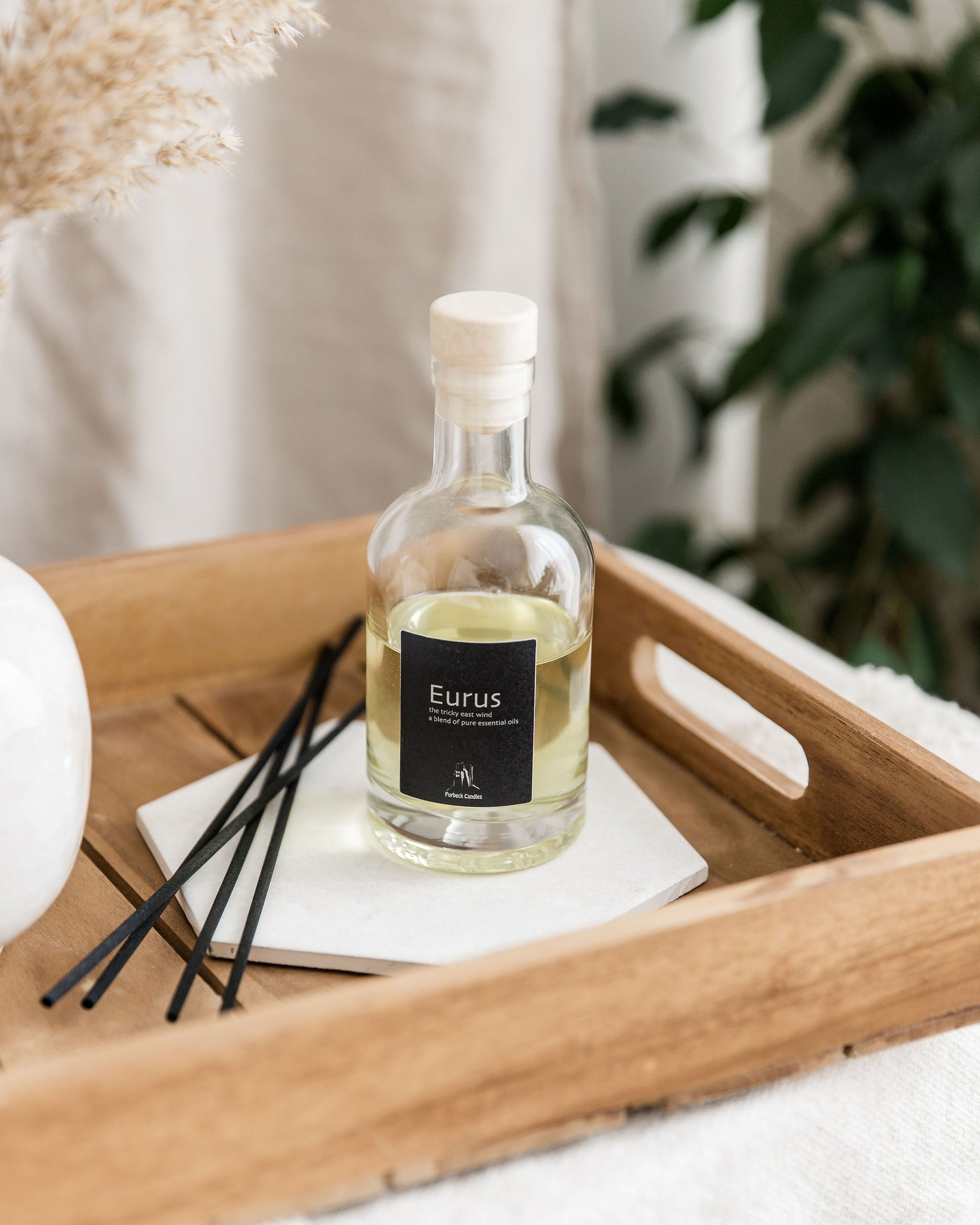 Bottle of Eurus on a wooden tray with decorative items