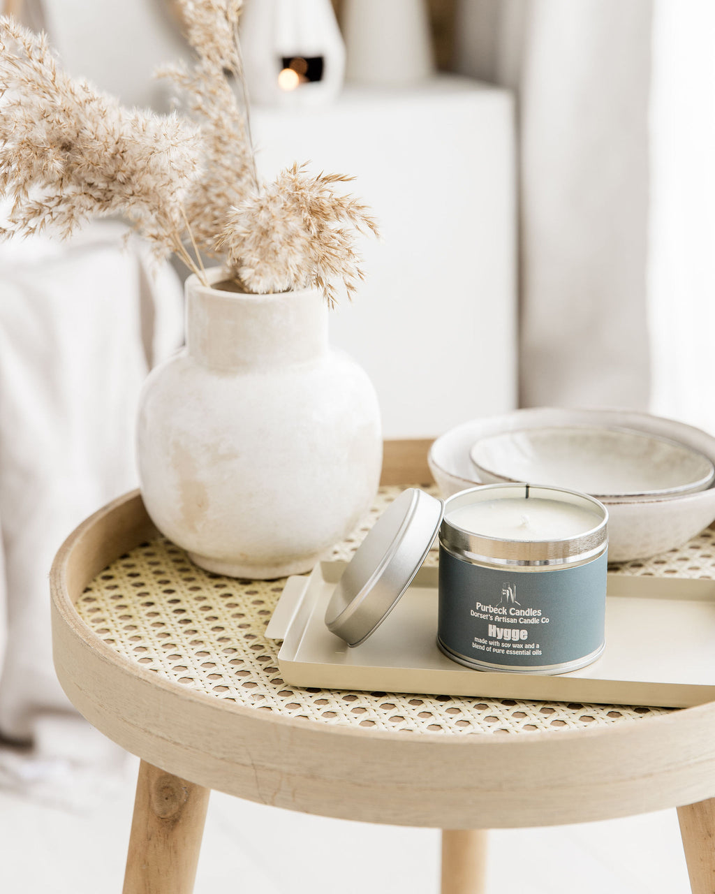 Candle on a woven table with decorative elements