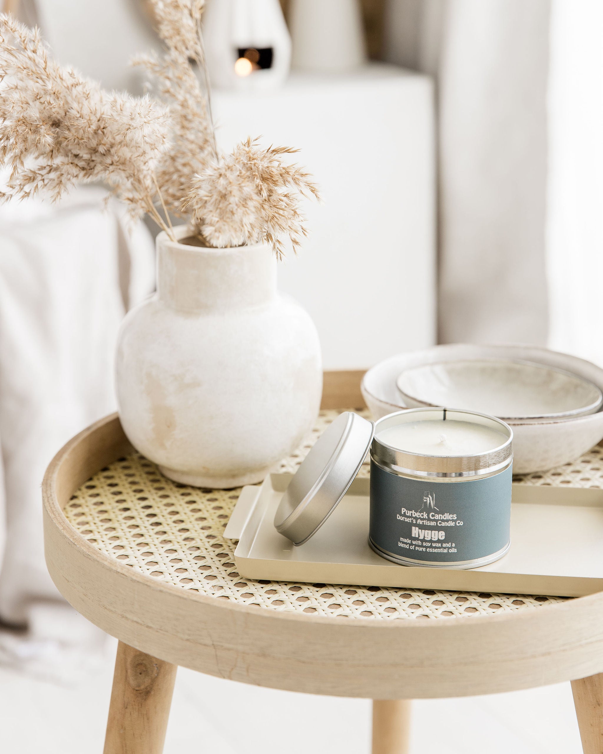 Candle on a woven table with decorative elements