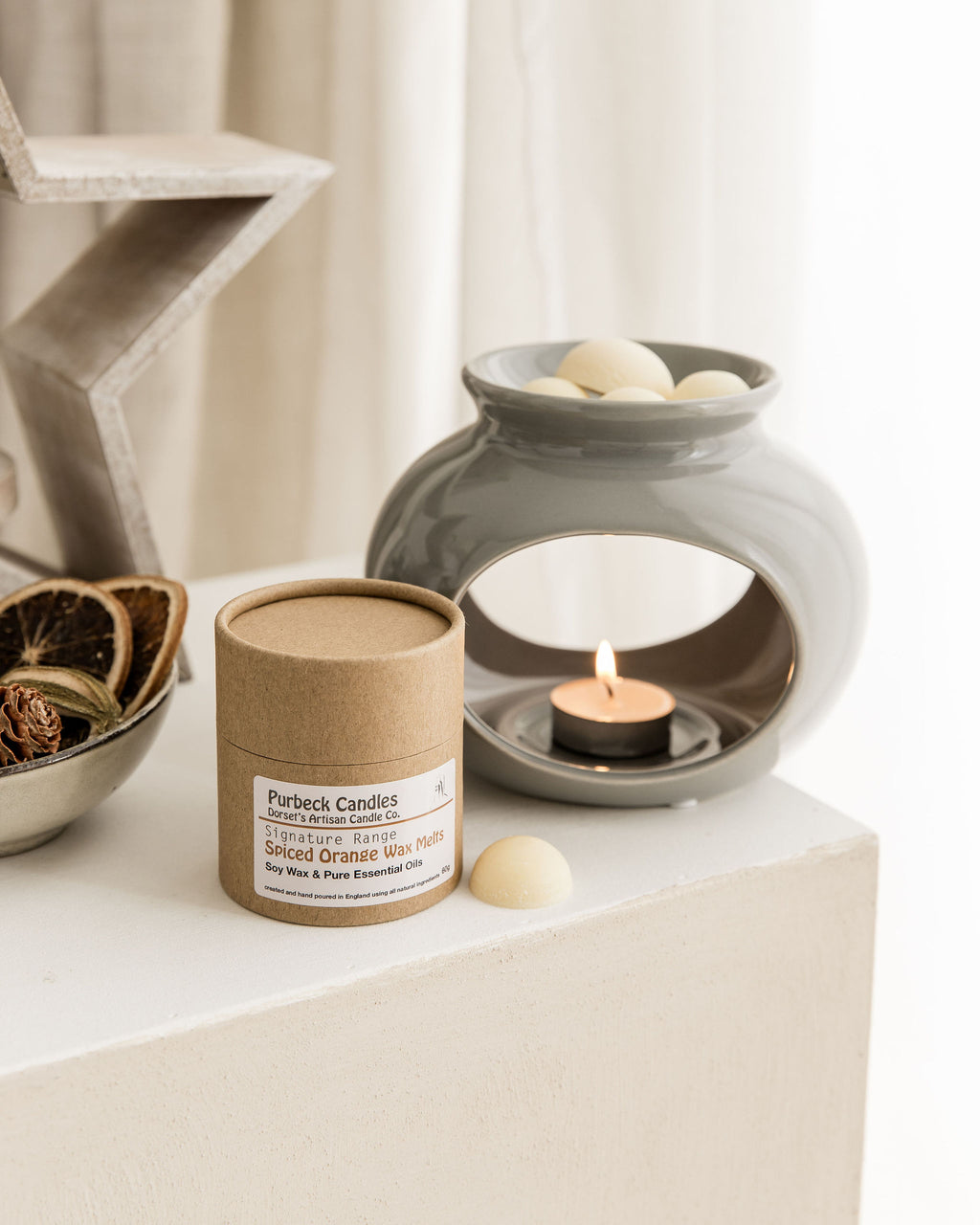 Purbeck Candles product on a shelf with a decorative lantern and candle