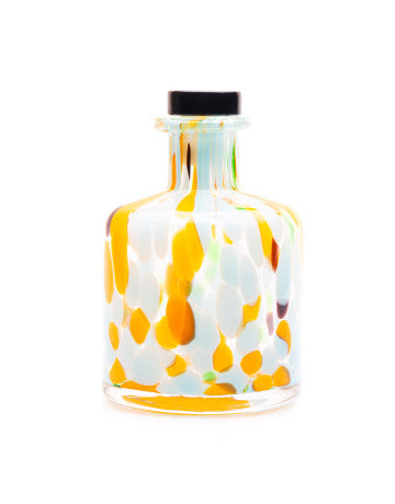Decorative glass bottle with colorful abstract design on a white background